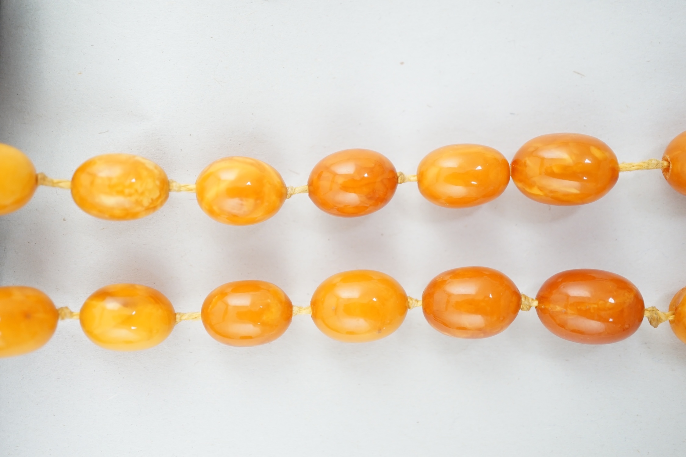 A single strand graduated oval amber bead necklace